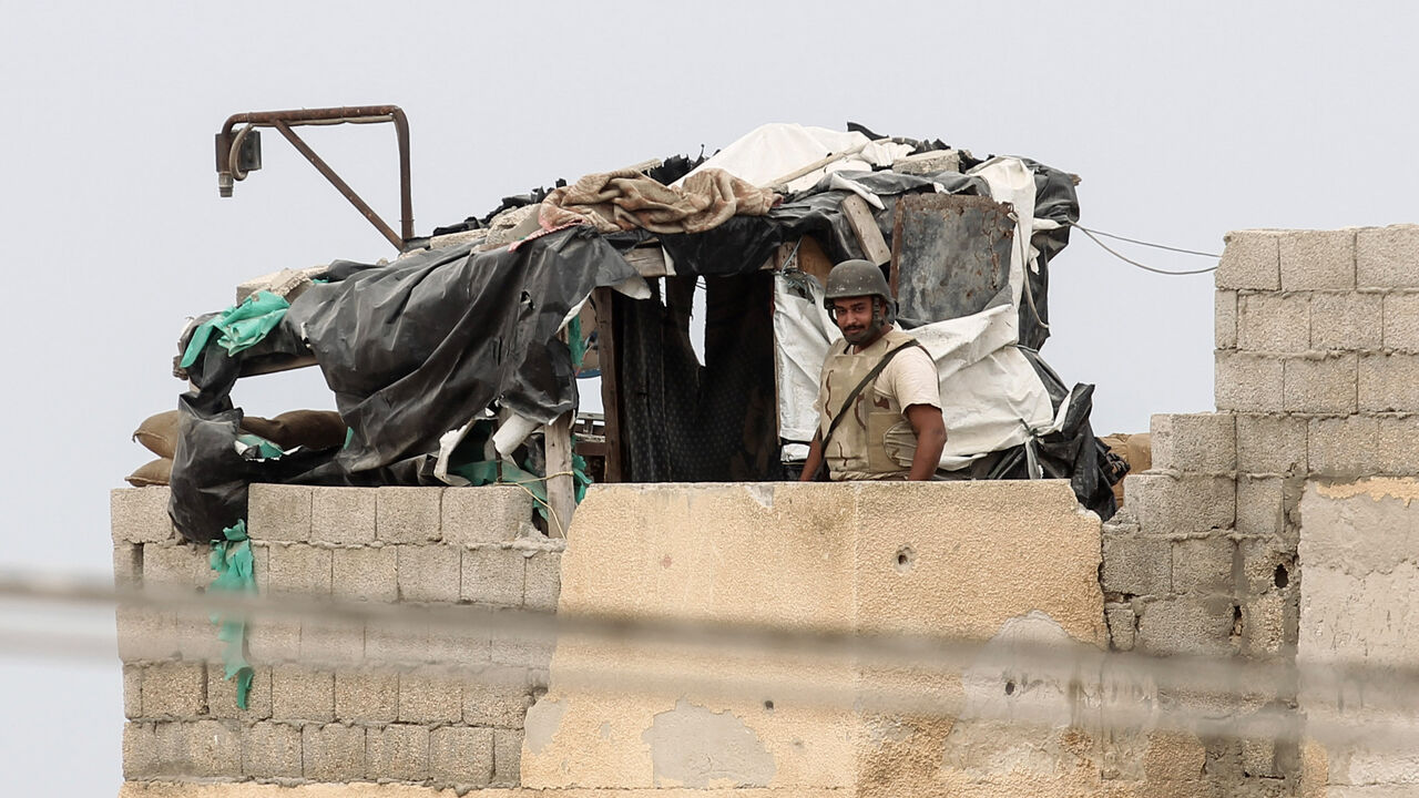 AFP_RM8ZO A picture taken from the southern Gaza Strip town of Rafah shows a member of the Egyptian forces standing guard near the border between Gaza and Egypt on August 17, 2017.
A suicide bomber killed a Hamas guard in southern Gaza, officials said, in what was seen as a rare Islamist attack against the Palestinian group that has run the impoverished enclave for a decade. / AFP PHOTO / SAID KHATIB (Photo credit should read SAID KHATIB/AFP/Getty Images)