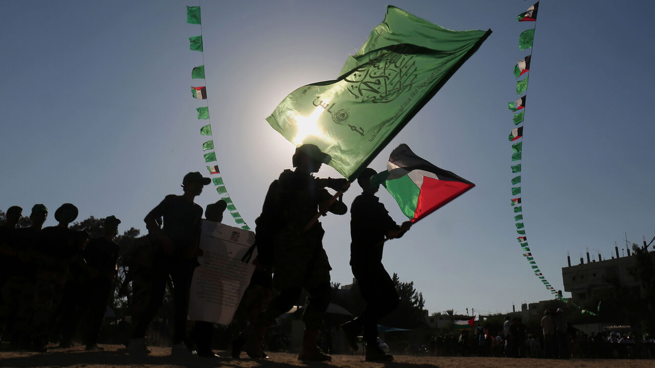 AFP_RO252 Young Palestinians march during in a military graduation ceremony at a Hamas summer camp in Khan Yunis, in the southern Gaza Strip, on August 18, 2017.
Hamas held a closing ceremony for a batch of the 120,000 boys and girls attending the Islamist movement's controversial summer schools. / AFP PHOTO / SAID KHATIB (Photo credit should read SAID KHATIB/AFP/Getty Images)