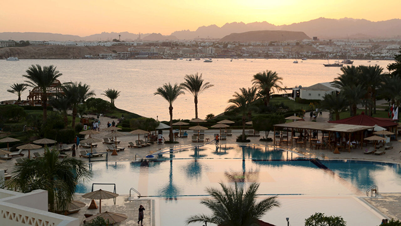 EGYPT-POLITICS/SINAI FILE PHOTO: A general view of Naama bay and a swimming pool of a hotel during sunset in the Red Sea resort of Sharm el-Sheikh, Egypt, November 7, 2015. To match Special Report EGYPT-POLITICS/SINAI REUTERS/Asmaa Waguih/File Photo - RTS14RT1