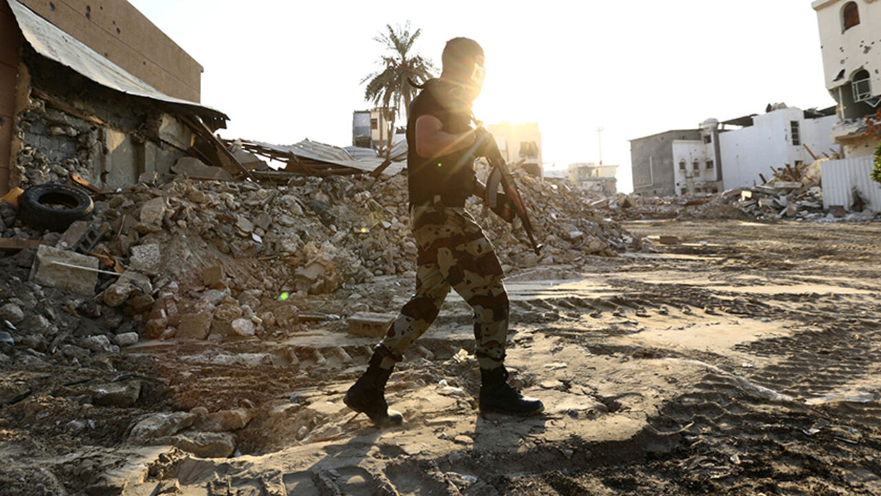 SAUDI-SECURITY/AWAMIYA A member of Saudi Special Forces holds his weapon as he walks in the town of Awamiya following a security campaign against Shi'ite Muslim gunmen, in the eastern part of Saudi Arabia August 9, 2017. REUTERS/Faisal Al Nasser - RTS1B3BC