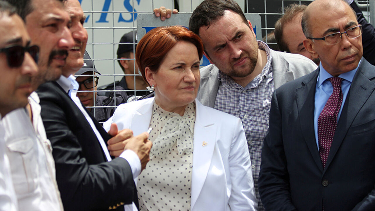 TURKEY-POLITICS/NATIONALISTS Meral Aksener (C), former interior minister and a lawmaker from Nationalist Movement Party (MHP), stands before the security barriers as police seal off a hotel, preventing dissidents from holding a party congress, in Ankara, Turkey, May 15, 2016. REUTERS/Tumay Berkin/File Photo - RTX2FHJV