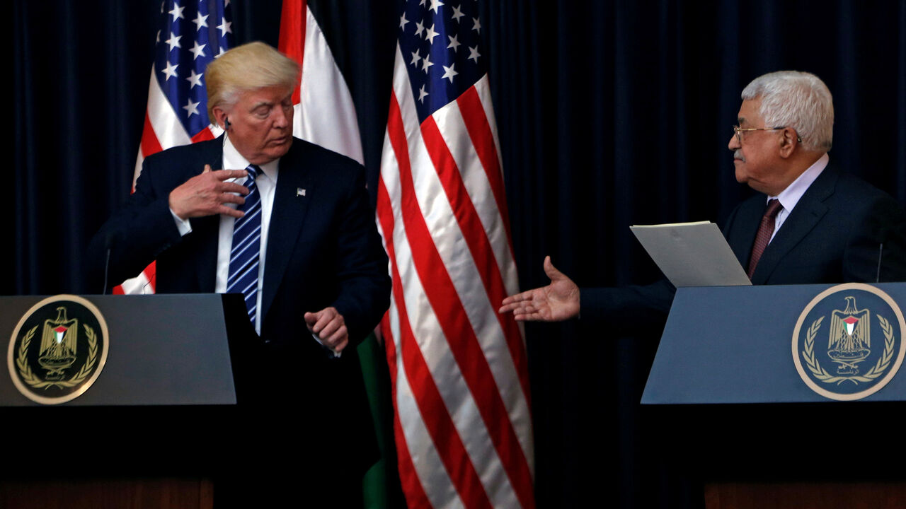 Palestinian President Mahmoud Abbas extends his hand to shake hands with U.S. President Donald Trump during a joint news conference at the presidential headquarters in the West Bank town of Bethlehem, May 23, 2017. REUTERS/Mohamad Torokman - RTX375A1