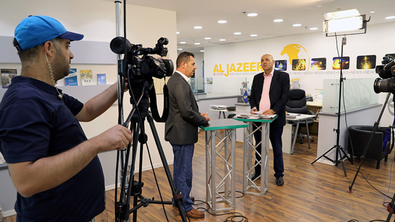 ISRAEL-ALJAZEERA/ Employees work inside the office of the Qatar-based Al-Jazeera network in Jerusalem August 7, 2017. REUTERS/Ammar Awad - RTS1APS5