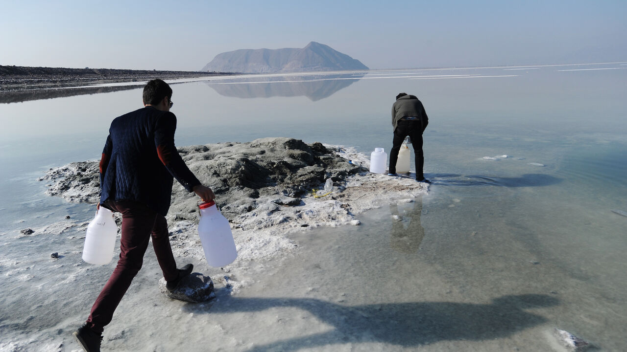 84057925 URMIEH, IRAN - JANUARY 23: Iranian university student Vahid Rezaei (R) and his brother Saeed Rezaei collect water samples from the salt-encrusted former lakebed of Iran's shrinking Lake Urmieh, which presents a risk of salt storms and future health and environmental problems on January 23, 2015 in Urmieh, northwest Iran. Once one of the largest salt lakes in the world, it has lost 90 percent of its volume in the past decade and symbolizes the scale of the water crisis facing Iran today. Decades of overuse,