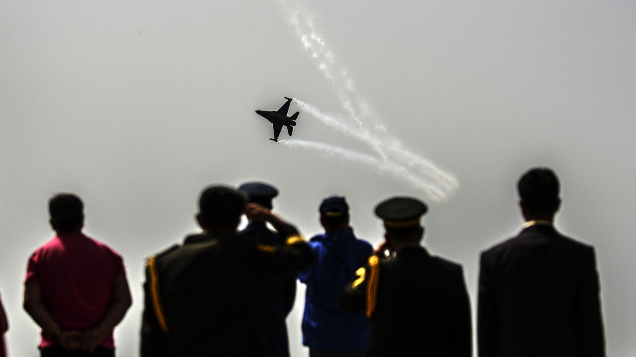 Par7862218 A Turkish air force patroller flies by as people watch the ceremony celebrating the 99th anniversary of Anzac Day in Canakkale on April 24, 2014. A dawn ceremony on April 25 marks the time of the first landings of the Australian and New Zealand Army Corps (ANZAC) at the Gallipoli peninsula in the ill-fated Allied campaign to take the Dardanelles Strait from the Ottoman Empire. In the ensuing eight months of fighting, about 11,500 ANZAC troops were killed, fighting alongside British, Indian and French soldie