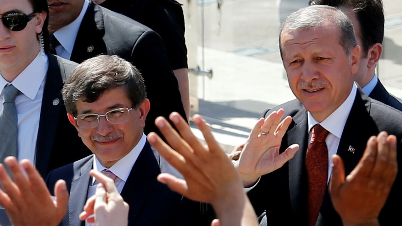 TURKEY-POLITICS/ Turkey's then-Prime Minister Tayyip Erdogan (R) and then-Foreign Minister Ahmet Davutoglu greet their supporters as they leave Friday prayers in Ankara, Turkey, August 22, 2014. REUTERS/Umit Bektas/File Photo - D1AETCCKOAAA