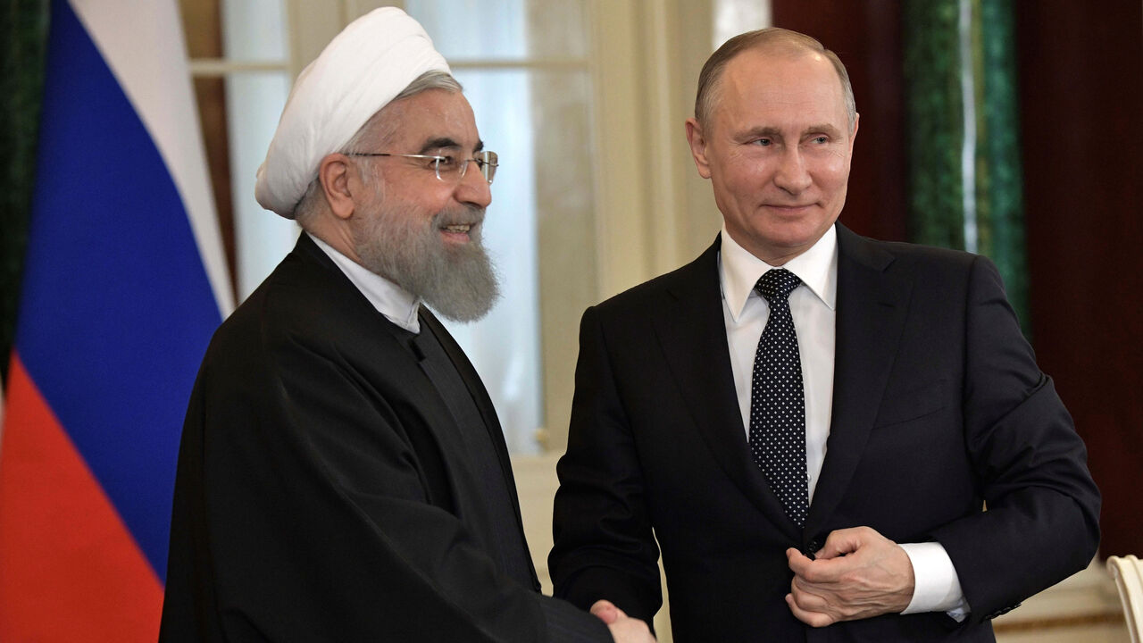 RUSSIA-IRAN/ROUHANI Russian President Vladimir Putin shakes hands with Iranian President Hassan Rouhani during a joint news conference following their meeting at the Kremlin in Moscow, Russia March 28, 2017. Sputnik/Aleksey Nikolskyi/Kremlin via REUTERS ATTENTION EDITORS - THIS IMAGE WAS PROVIDED BY A THIRD PARTY. EDITORIAL USE ONLY. - RC1DD5047B80