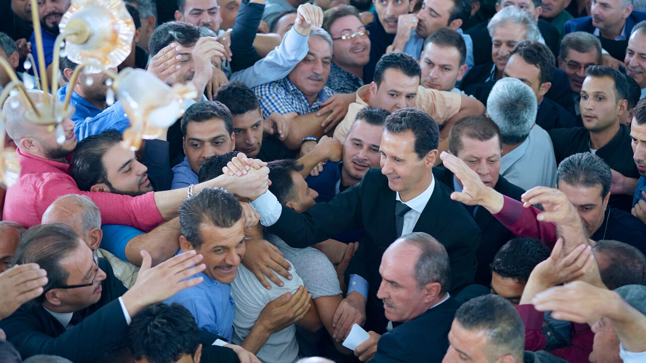 MIDEAST-CRISIS/SYRIA Syria's President Bashar al-Assad greets his supporters during Eid al-Adha prayers at a mosque in the town of Qara, north of Damascus, in this handout picture provided by SANA on September 1, 2017, Syria. SANA/Handout via REUTERS ATTENTION EDITORS - THIS IMAGE WAS PROVIDED BY A THIRD PARTY. REUTERS IS UNABLE TO INDEPENDENTLY VERIFY THIS IMAGE. - RC1EA1EC0D40