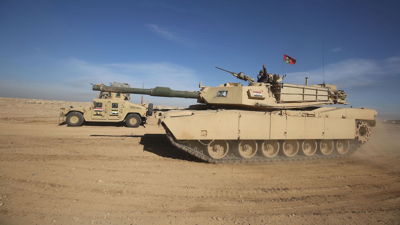 Iraqi forces, supported by the Hashed al-Shaabi (Popular Mobilisation) paramilitaries, advance near the village of Husseinyah, south of Mosul on February 20, 2017, during the offensive to retake the western side of Mosul. / AFP / AHMAD AL-RUBAYE        (Photo credit should read AHMAD AL-RUBAYE/AFP/Getty Images)