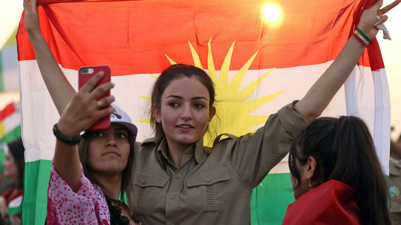 AFP_SN3B9 An Iranian Kurdish woman holds a Kurdish flag as she takes part in a gathering to urge people to vote in the upcoming independence referendum in the town of Bahirka, north of Arbil, the capital of the autonomous Kurdish region of northern Iraq, on September 21, 2017.
The controversial referendum on independence for Iraqi Kurdistan is set for September 25. / AFP PHOTO / SAFIN HAMED (Photo credit should read SAFIN HAMED/AFP/Getty Images)