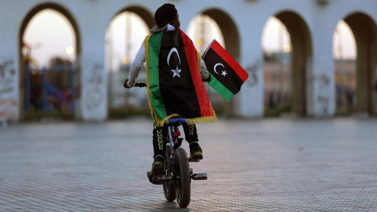 LIBYA-ANNIVERSARY/ A boy wearing a Libyan flag takes part in a celebration marking the sixth anniversary of the Libyan revolution, in Benghazi, Libya February 17, 2017. REUTERS/Esam Omran Al-Fetori TPX IMAGES OF THE DAY - RC1CEEEEB180