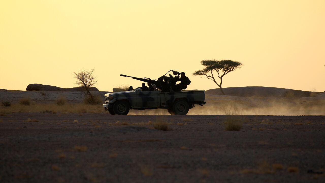 WESTERNSAHARA-DISPUTE/ The Polisario Front soldiers drive a pick-up truck mounted with an anti-aircraft weapon during sunset in Bir Lahlou, Western Sahara, September 9, 2016. REUTERS/Zohra Bensemra SEARCH ìPOLISARIOî FOR THIS STORY. SEARCH "WIDER IMAGE" FOR ALL STORIES. - S1BEUKRIISAA