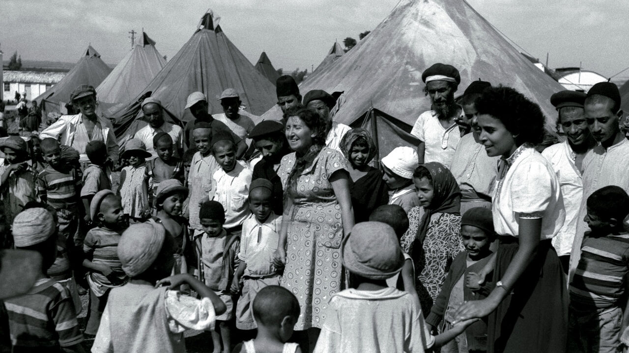 FILE PHOTO 1OCT49 - Jewish immigrants from Yemen in a tent encampment in 1949 as they are visited by Israeli nurses. Many Jewish immigrants of Sephardic origin from North Africa and the Middle East were shipped to Israeli development town when they arrived, while many of the European, or Ashkenazi, immigrants were able to start their new lives in Israel's cities with promising jobs. Most of the Yemenites arrived in Israel during "Operation Magic Carpet" in the late 1940's. In the 1950's and 60's some 300,00