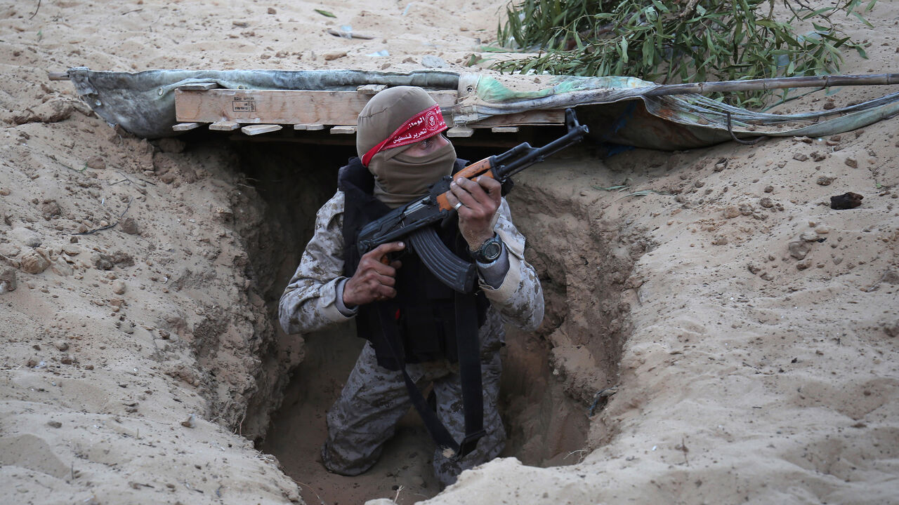 AFP_HS2RB A Palestinian militant of the National Resistance brigades, the armed wing of the Democratic Front for the Liberation of Palestine (DFLP), gets out of a tunnel during a graduation ceremony in Rafah, in the southern Gaza Strip, on November 4, 2016. / AFP / SAID KHATIB (Photo credit should read SAID KHATIB/AFP/Getty Images)