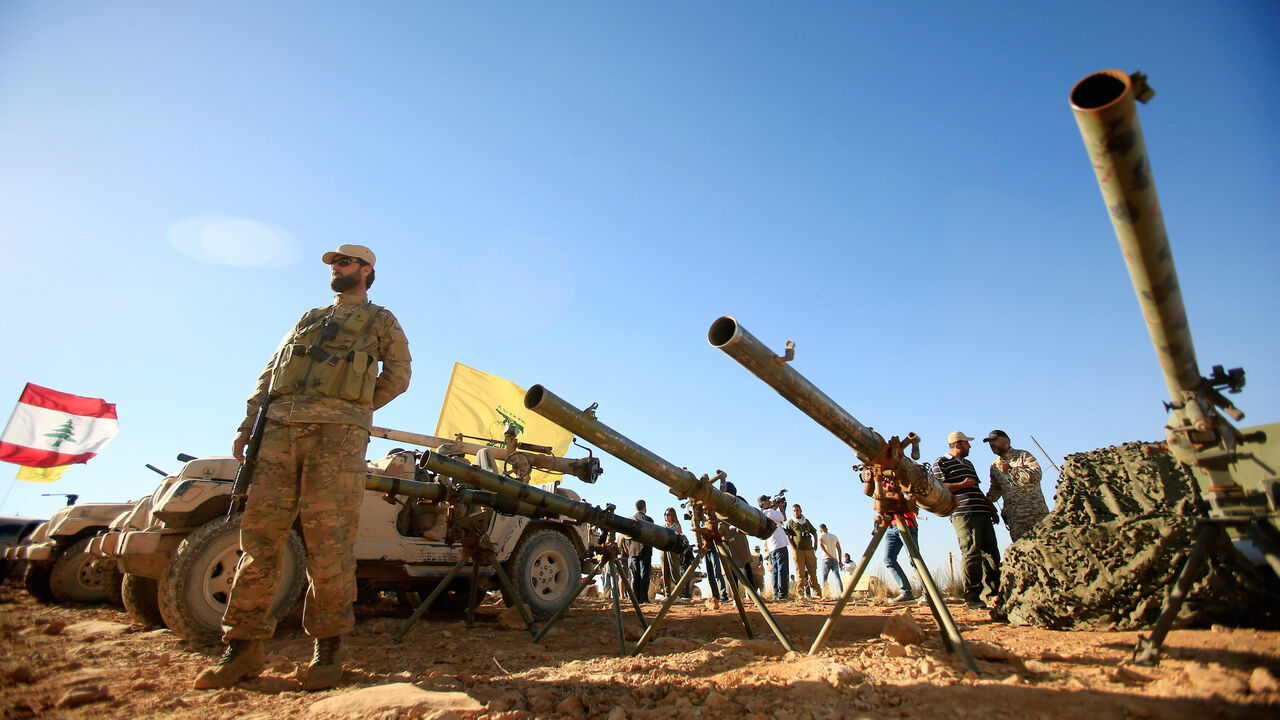MIDEAST-CRISIS/SYRIA-LEBANON A Hezbollah fighter stands in front of anti-tank artillery at Juroud Arsal, the Syria-Lebanon border, July 29, 2017. REUTERS/Ali Hashisho TPX IMAGES OF THE DAY - RC1B7DA4AC10