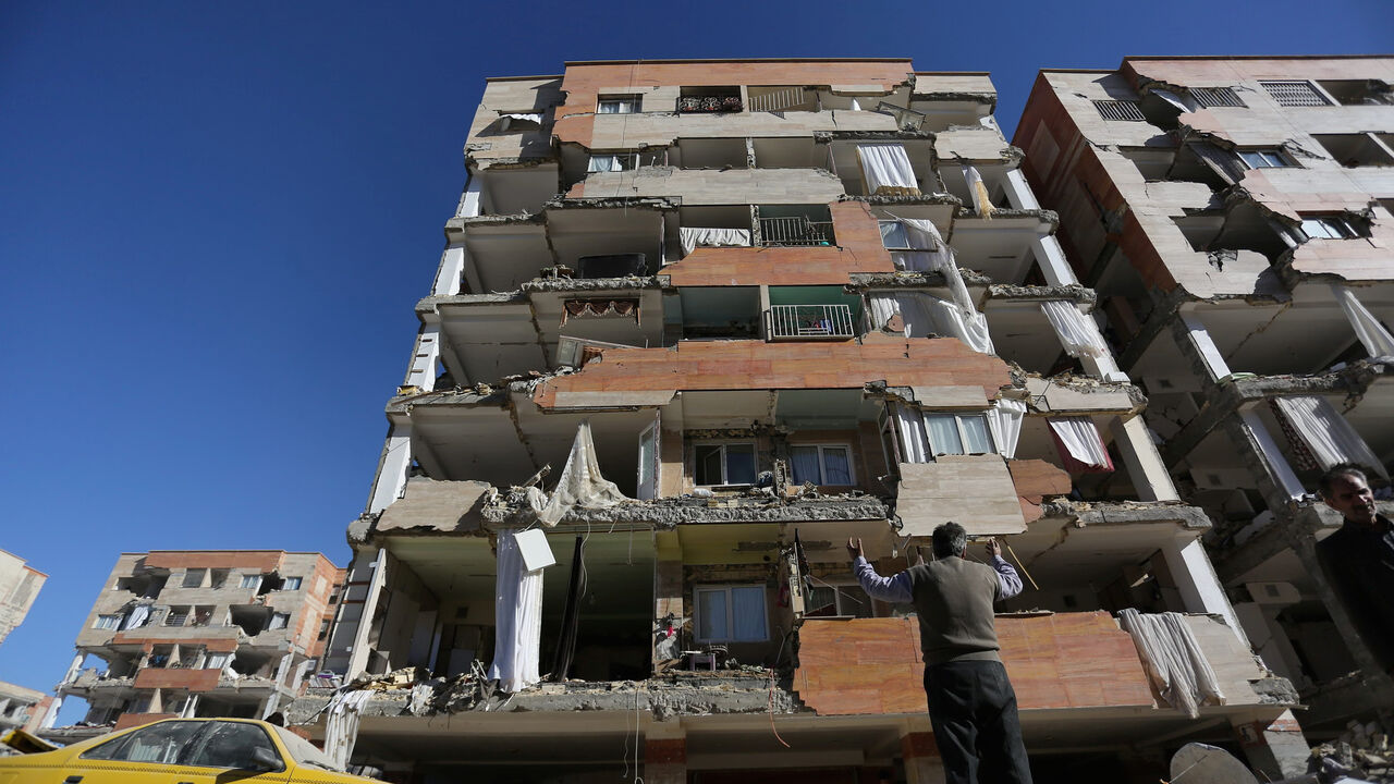 IRAQ-QUAKE/IRAN A man reacts as he looks at a damaged building following an earth quake in Sarpol-e Zahab county in Kermanshah, Iran November 13, 2017. REUTERS/Tasnim News Agency ATTENTION EDITORS - THIS PICTURE WAS PROVIDED BY A THIRD PARTY. - RC1197D36C20