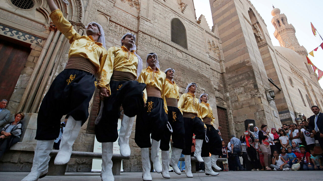 EGYPT-AFROCHINESE FESTIVAL Members of an Arabian group perform a traditional Dabke folk dance during the African-Chinese cultural festival, organised by Egypt's Ministry of Tourism, on the historic Moez Street, in Cairo, Egypt July 25, 2016. Picture taken July 25, 2016. REUTERS/Amr Abdallah Dalsh - D1BETSEAVPAA