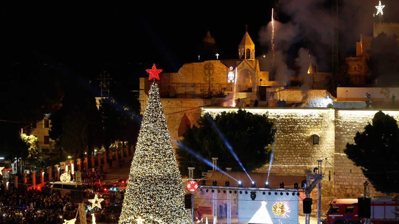 PALESTINIANS-RELIGION/ Fireworks explode during a Christmas tree lighting ceremony outside the Church of the Nativity in the West Bank town of Bethlehem December 3, 2016. REUTERS/Mussa Qawasma - RC1514D50930