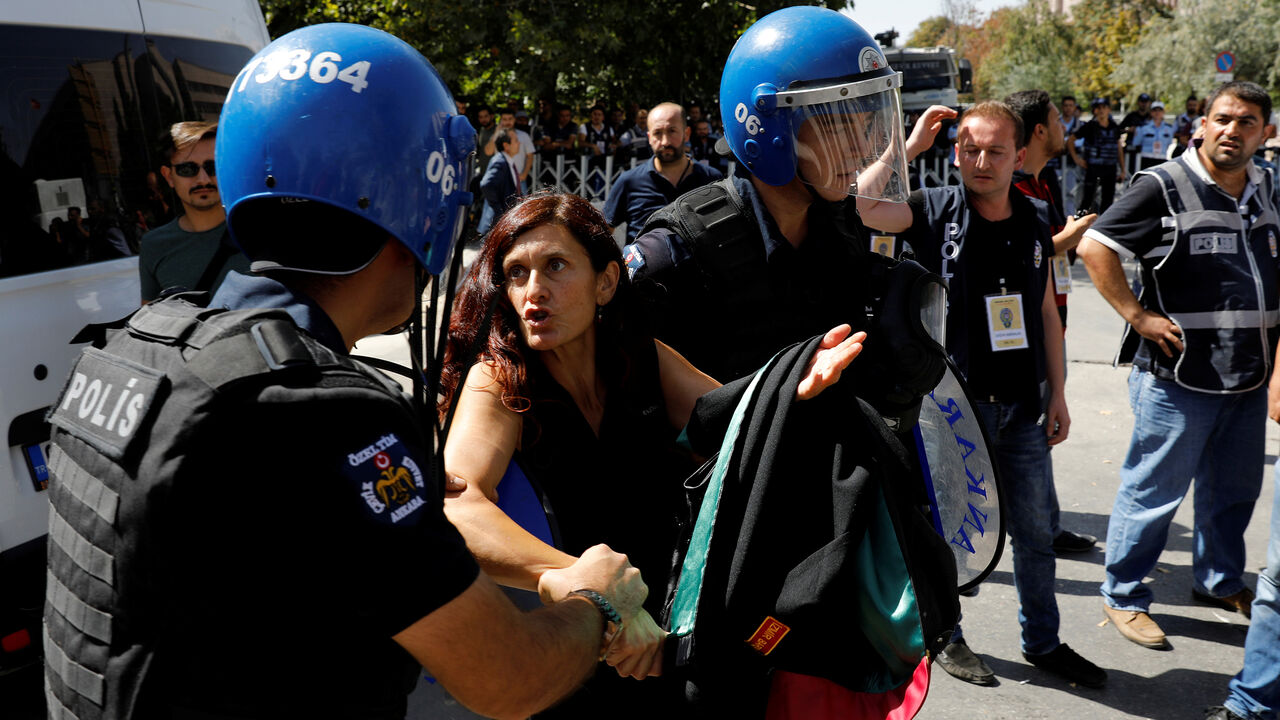 TURKEY-SECURITY/TRIAL Lawyer Ruken Arslan detained by riot police during the trial of two Turkish teachers, who went on a hunger strike over their dismissal under a government decree following last year's failed coup, outside of a courthouse in Ankara, Turkey September 14, 2017. REUTERS/Umit Bektas - RC11F5408250