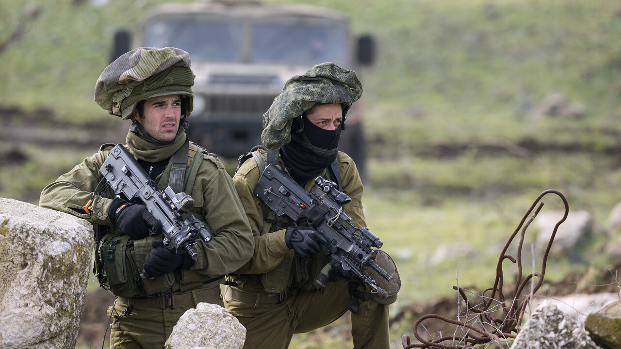 Israeli soldiers from the Golani Brigade take part in a military training exercise in the Israeli-annexed Golan Heights near the border with Syria on January 19, 2015. Iran confirmed today that a general of its elite Revolutionary Guards died in an Israeli strike on Syria that also killed six members of Lebanese militant group Hezbollah.  AFP PHOTO / JACK GUEZ        (Photo credit should read JACK GUEZ/AFP/Getty Images)