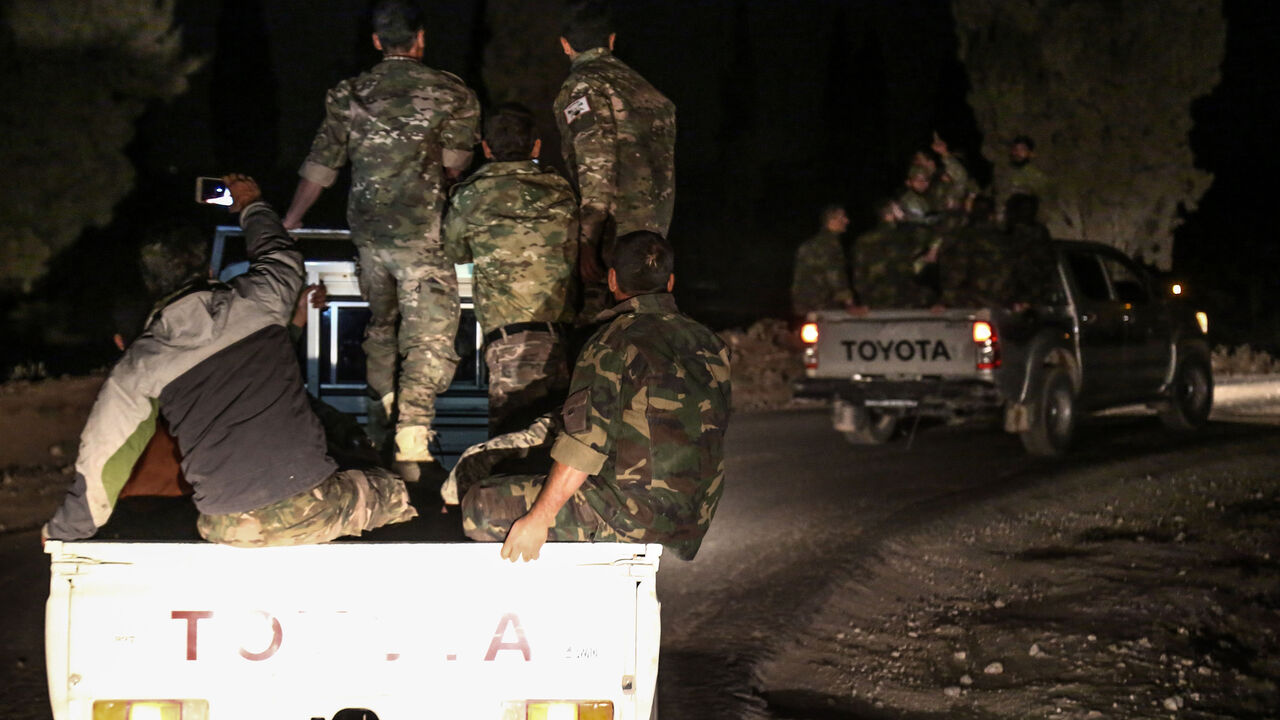 AFP_T67NT Pro-Ankara Syrian rebel fighters are seen riding on pickup trucks near the village of Hawar Killis along the Syrian-Turkish border in the northern province of Aleppo on October 6, 2017, as they advance towards jihadist-controlled Idlib province.
Turkish President Recep Tayyip Erdogan said in a televised speech on October 7 that the pro-Ankara Syrian rebels were "taking new steps to ensure security in Idlib".
Erdogan later told reporters the operation was led by "Free Syrian Army" (FSA) rebels and that the T