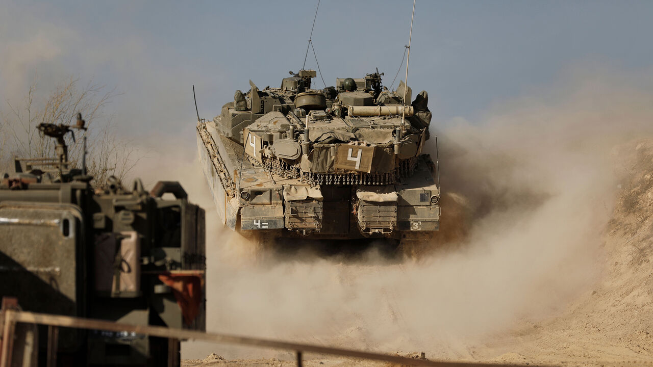A picture taken on November 16, 2017, shows an Israeli soldier driving a tank at an army position overlooking southern Lebanon in the northern Israeli town of Metula, along Israel's border with Lebanon. / AFP PHOTO / MENAHEM KAHANA        (Photo credit should read MENAHEM KAHANA/AFP/Getty Images)