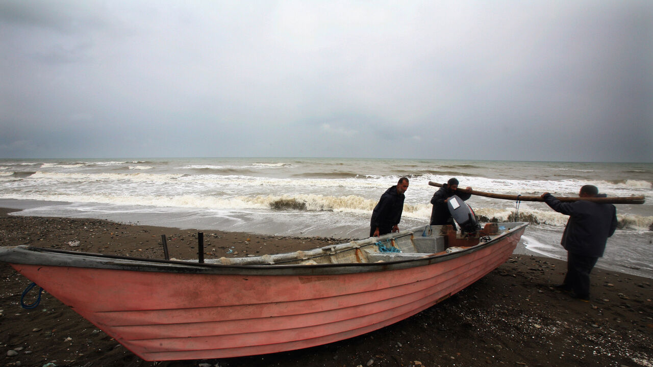 IRAN CAVIAR Iranian fishermen return to shore after checking their nets for sturgeon in the Caspian Sea near Rezvanshahr 410km (254 miles) northwest of Tehran October 3, 2006. In April 2006 a U.N. body set up to safeguard endangered species said it was extending a ban on the export of caviar from the Caspian Sea for all countries except Iran. Iranians are trying to combat the demise of the sturgeon with ambitious networks of hatcheries, designed to replenish stocks by releasing millions of young fish each year. Environ