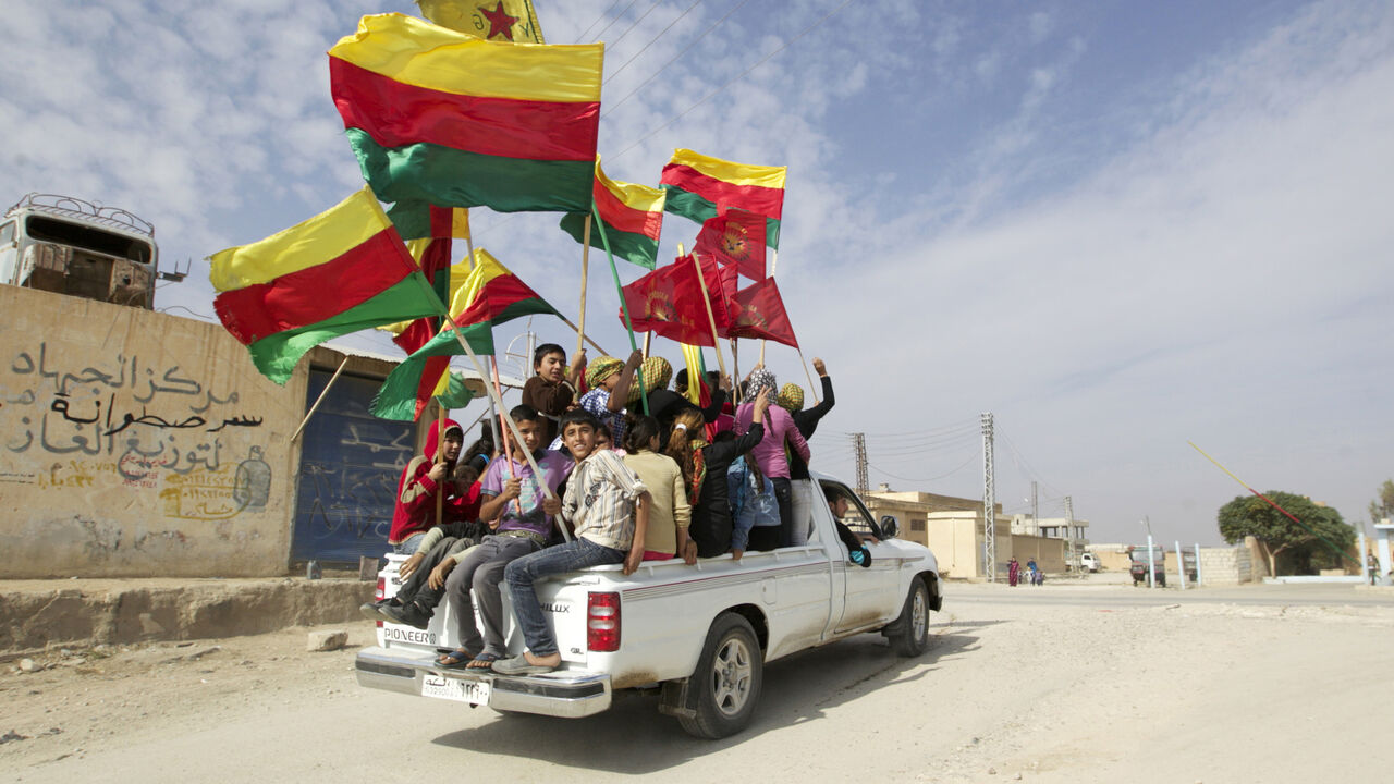 SYRIA-CRISIS/KURDS People sit in the back of a truck as they celebrate what they said was the liberation of villages from Islamist rebels near the city of Ras al-Ain in the province of Hasakah, after capturing it from Islamist rebels November 6, 2013. Redur Xelil, spokesman for the armed wing of the Syrian Kurdish Democratic Union Party (PYD), said Kurdish militias had seized the city of Ras al-Ain and all its surrounding villages. Syrian Kurdish fighters have captured more territory from Islamist rebels in northeastern Syria