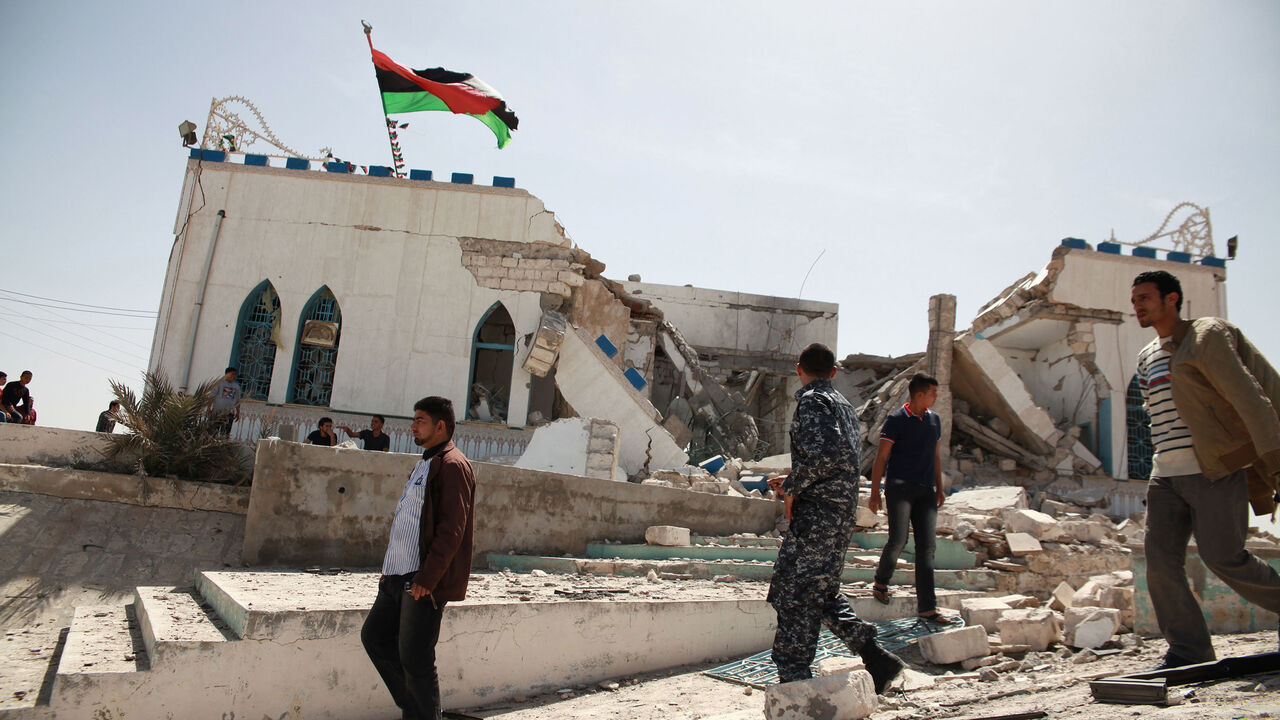 LIBYA/ People inspect the damage done to a Sufi shrine, the tomb of Sidi Mohamed Landoulsi, after an explosion in the Tajoura neighbourhood on the outskirts of Tripoli, March 28, 2013. An explosion damaged the shrine early in the morning on Thursday, according to a witness. REUTERS/Stringer (LIBYA - Tags: POLITICS CIVIL UNREST RELIGION) - GM1E93S1S7K01