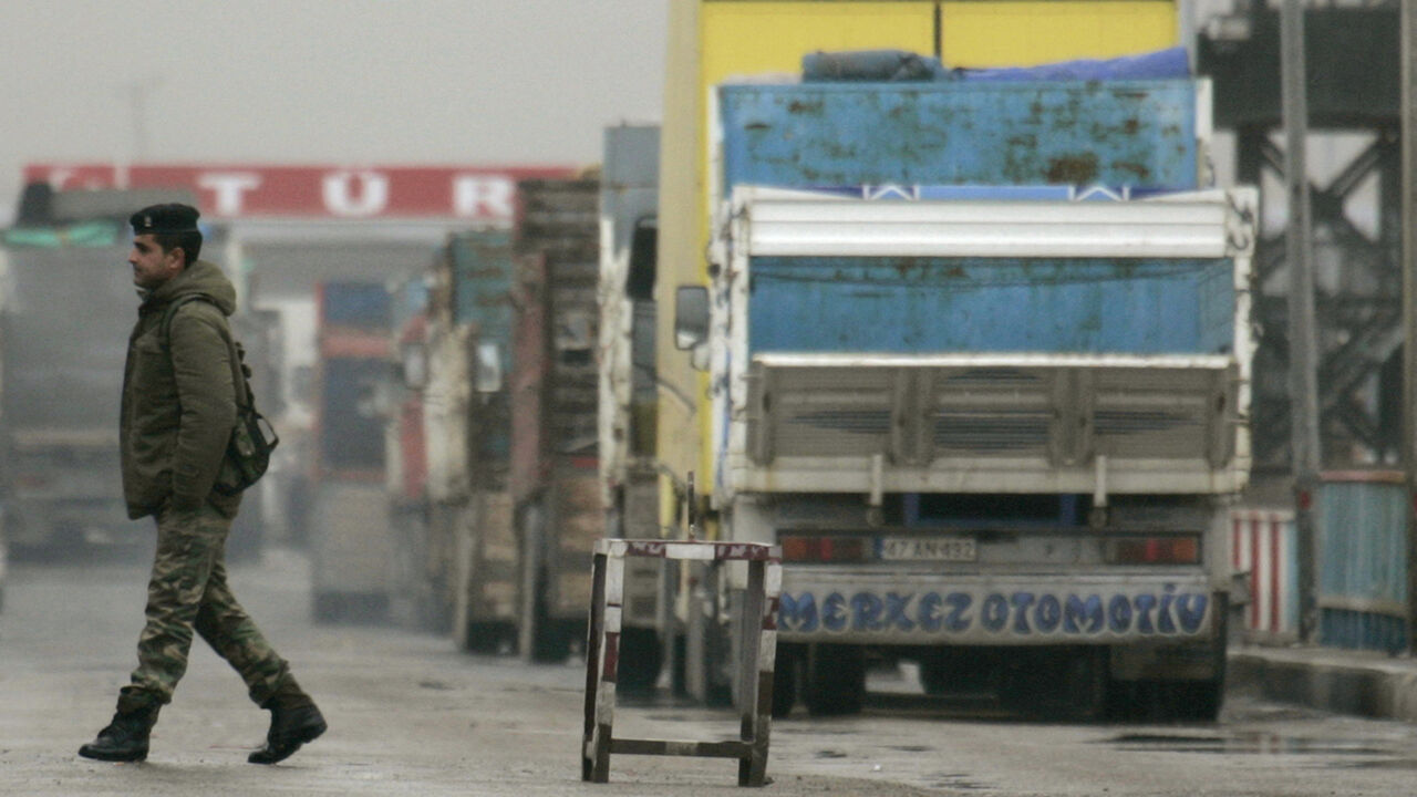 A soldier walks at Ibrahim Khalil border gate between Iraq and Turkey, near Zakhu, February 26, 2008. Turkish products dominate shop shelves in Iraq's Kurdish north. So, even as residents here seethe in anger at Turkey's big military incursion into their homeland, they cannot afford to cut the economic lifeline with their larger neighbour. Picture taken February 26, 2008.    To match feature IRAQ-TURKEY/TRADE     REUTERS/Ceerwan Aziz (IRAQ) - GM1E42R1FKC01
