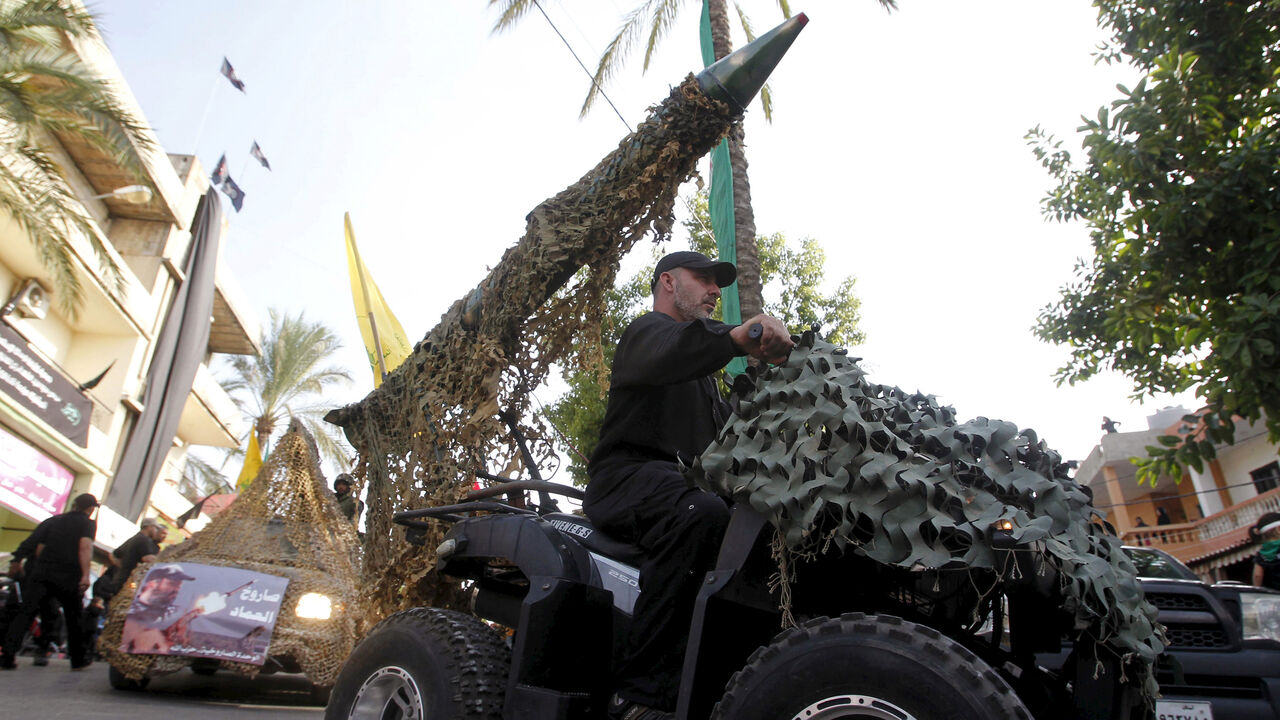 LEBANON-RELIGION/ A Hezbollah member drives a 4-wheel motorbike mounted with a mock rocket during a re-enactment of the battle of Kerbala during a mourning process, ahead of the day of Ashura, in Saksakieh village, southern Lebanon, October 18, 2015. Ashoura, the most important day in the Shi'ite calendar, commemorates the death of Imam Hussein, grandson of the Prophet Mohammad, in the 7th century battle of Kerbala. REUTERS/Ali Hashisho - GF10000249852