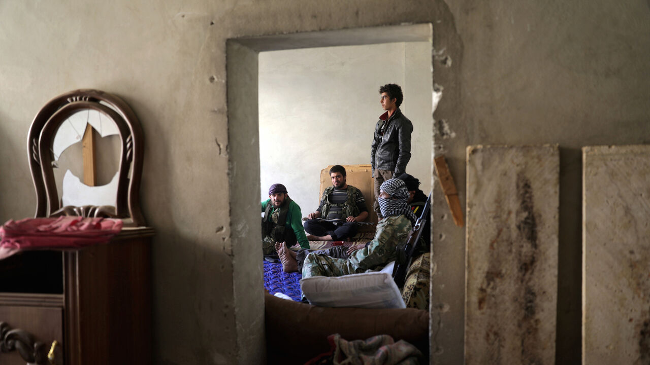 MIDEAST-CRISIS/SYRIA Free Syrian Army fighters sit together in the town of Tadef in Aleppo Governorate, Syria October 23, 2017. REUTERS/Khalil Ashawi - RC19D8DC3BD0