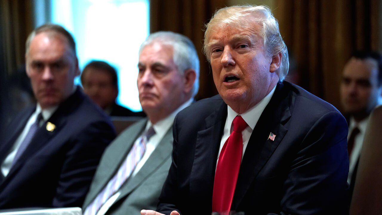 USA-TRUMP/ U.S. President Donald Trump, flanked by Interior Secretary†Ryan Zinke and Secretary of State Rex Tillerson, holds a cabinet meeting at the White House in Washington, U.S., January 10, 2018. REUTERS/Jonathan Ernst - RC113BF0A9B0