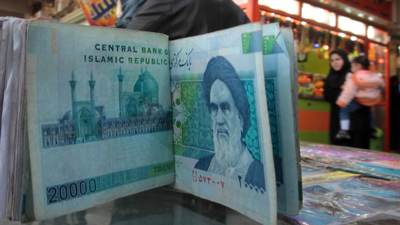 Nic6056865 An Iraqi money dealer counts Iranian rial banknotes bearing a portrait of the late founder of the Islamic Republic of Iran, Ayatollah Ruhollah Khomeini, at an exchange office in Baghdad on February 3, 2012. Tens of thousands of Iranian visitors have been finding difficulty in using the Iranian currency in Iraq due to a depreciation of the rial against the dollar. AFP PHOTO/ ALI AL-SAADI (Photo credit should read ALI AL-SAADI/AFP/Getty Images)