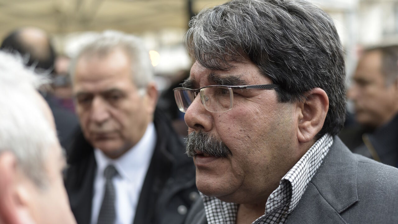 ARP4339547 Salih Muslim Muhammad chairman of the PYD, the Syrian branch of the PKK answers journalists' questions as he arrives to pay tribute to the victims of the attacks claimed by Islamic State which killed at least 129 people and left more than 350 injured, on November 17, 2015 in front of the Bataclan theatrein Paris. AFP PHOTO / ADRIEN MORLENT (Photo credit should read ADRIEN MORLENT/AFP/Getty Images)