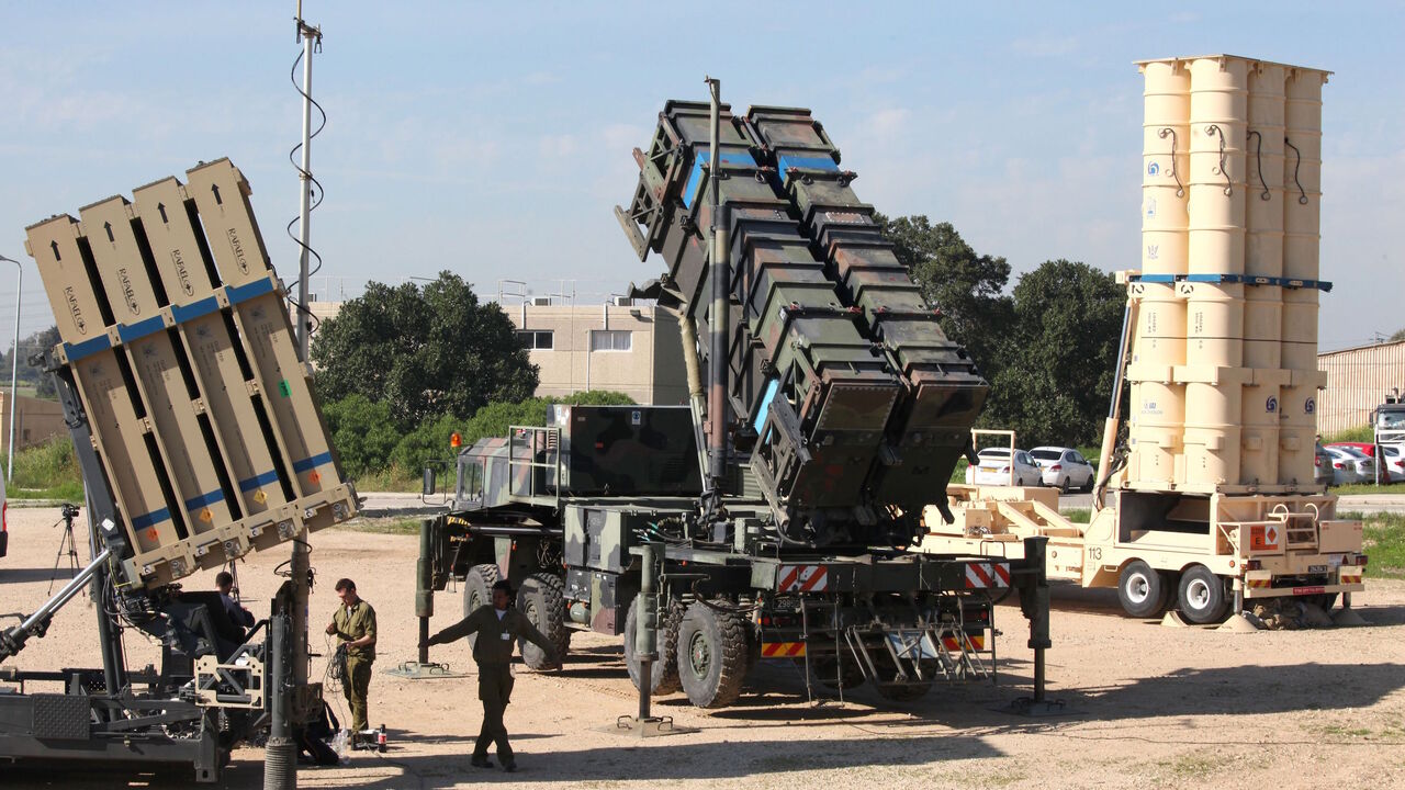 AFP_886FC Israeli soldiers walk near an Israeli Irone Dome defence system (L), a surface-to-air missile (SAM) system, the MIM-104 Patriot (C), and an anti-ballistic missile the Arrow 3 (R) during Juniper Cobra's joint exercise press briefing at Hatzor Israeli Air Force Base in central Israel, on February 25, 2016.
Juniper Cobra, is held every two years where Israel and the United States train their militaries together to prepare against possible ballistic missile attacks, as well as allowing the armies to learn to be