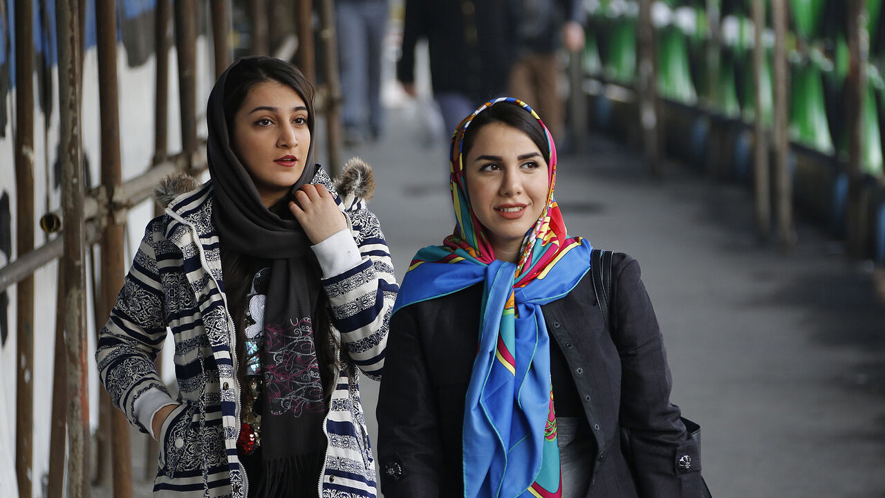 AFP_YZ8Y9 Iranian women wearing hijab walk down a street in the capital Tehran on February 7, 2018.
A spate of unprecedented protests against Iran's mandatory headscarves for women have been tiny in number, but have still reignited a debate that has preoccupied the Islamic republic since its founding. / AFP PHOTO / ATTA KENARE (Photo credit should read ATTA KENARE/AFP/Getty Images)