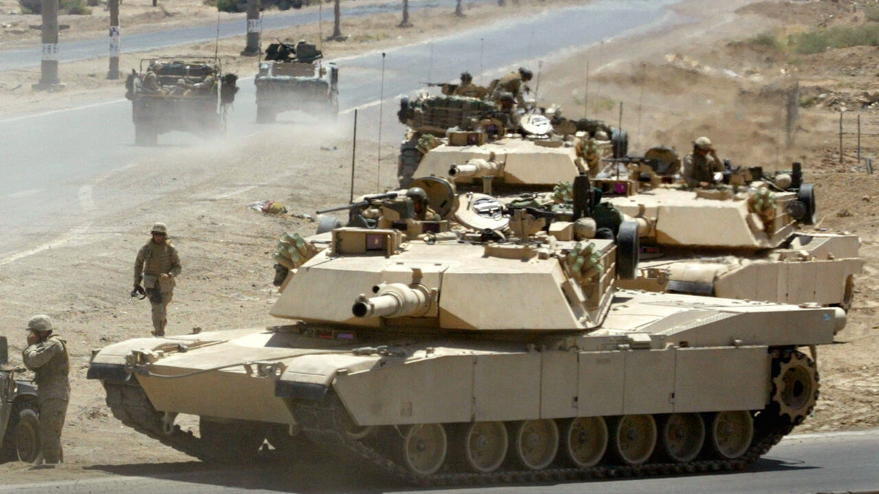 IRAQ U.S. Marine M1 Abrams tanks from the 2nd Battalion of the 1st Marine Division take up defensive positions during a firefight near the main traffic checkpoint in Falluja June 24, 2004. A U.S. Marine Cobra helicopter gunship was shot down during the battle but the two pilots escaped uninjured. At least 15 insurgents were killed and three Marines injured in the fighting, a military spokesman said. REUTERS/Bob Strong RCS/acm - RP5DRHZSARAA