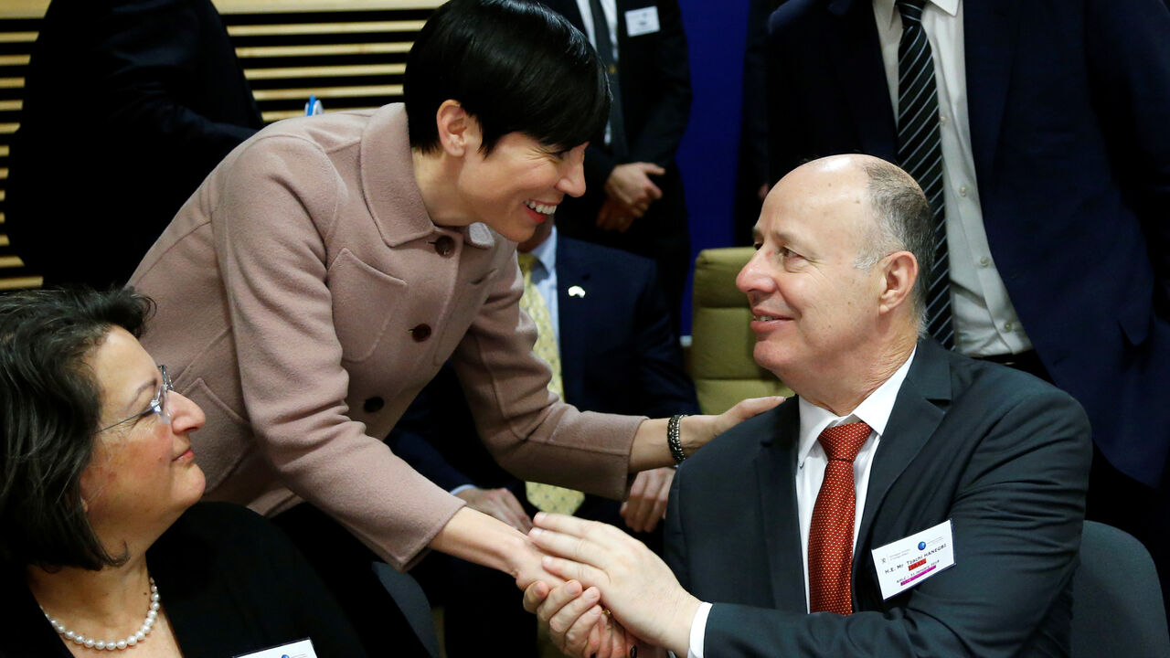 MIDEAST-DONORS/ Norway's Foreign Minister Ine Marie Eriksen Soreide greets Israeli Minister of Regional Cooperation Tzachi Hanegbi during a session of the International Donor Group for Palestine at the EU Commission headquarters in Brussels, Belgium, January 31, 2018. REUTERS/Francois Lenoir - RC15AF17F6A0