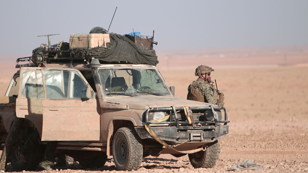 MIDEAST-CRISIS/SYRIA-RAQQA A U.S. fighter stands near a military vehicle, north of Raqqa city, Syria November 6, 2016. REUTERS/Rodi Said - S1AEULHHBDAA