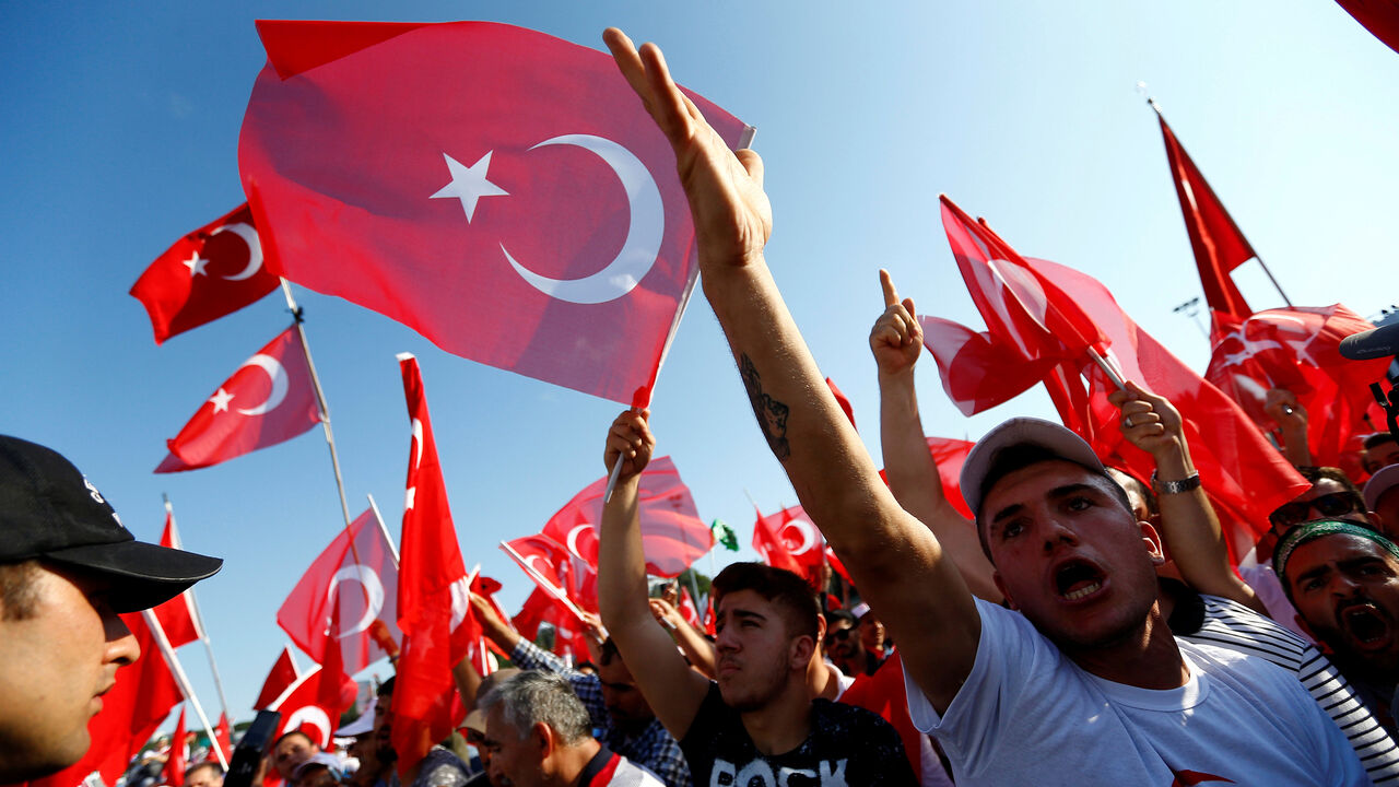 TURKEY-SECURITY/ANNIVERSARY People wave Turkey's national flags as they arrive to attend a ceremony marking the first anniversary of the attempted coup at the Bosphorus Bridge in Istanbul, Turkey, July 15, 2017. REUTERS/Murad Sezer TPX IMAGES OF THE DAY - RC14FF737300