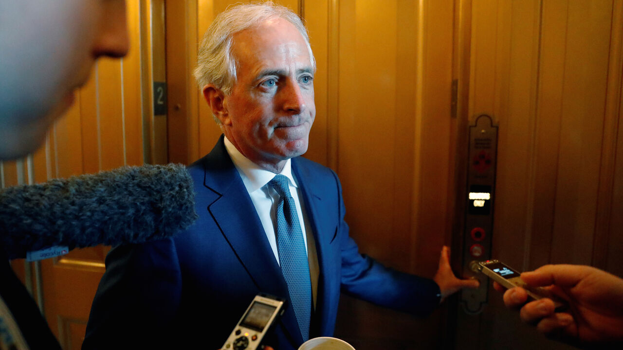 USA-TAX/ U.S. Senator Bob Corker (R-TN) speaks with reporters as he walks from the Senate floor between votes on procedural measures leading up to potential tax overhaul legislation at the U.S. Capitol in Washington, U.S., December 1, 2017. REUTERS/Jonathan Ernst - RC1657C8AC00