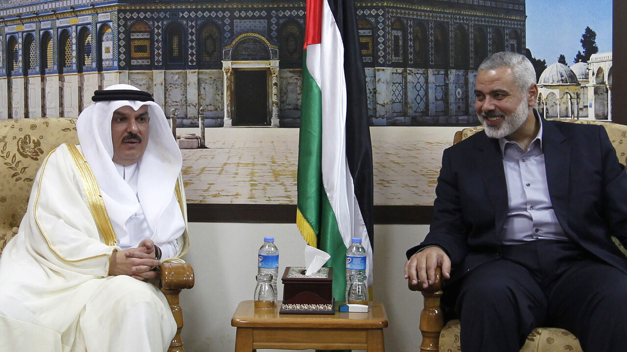 Head of the Hamas government in the Gaza Strip, Ismail Haniya (R), meets with the head of a Qatari delegation Mohammed al-Emadi in Gaza City on September 25, 2012, where a number of projects included in the Qatari grant for the reconstruction of Gaza are expected to be launched. AFP PHOTO/MOHAMMED ABED        (Photo credit should read MOHAMMED ABED/AFP/GettyImages)
