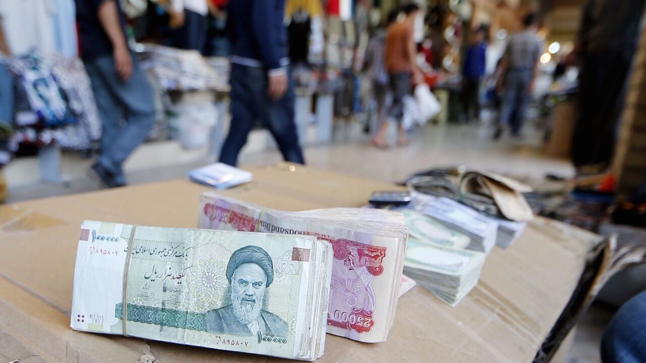 Nic6340661 Iranian rial banknotes bearing a portrait of the late founder of the Islamic Republic of Iran, Ayatollah Ruhollah Khomeini, sit on the stand of an Iraqi money dealer on June 19, 2014, in Arbil, the capital of the autonomous Kurdish region of northern Iraq. President Hassan Rouhani said on June 18 Iran would do whatever it takes to protect revered Shiite shrines in Iraq against Sunni militants fighting the Baghdad government. AFP PHOTO/KARIM SAHIB (Photo credit should read KARIM SAHIB/AFP/Getty Images
