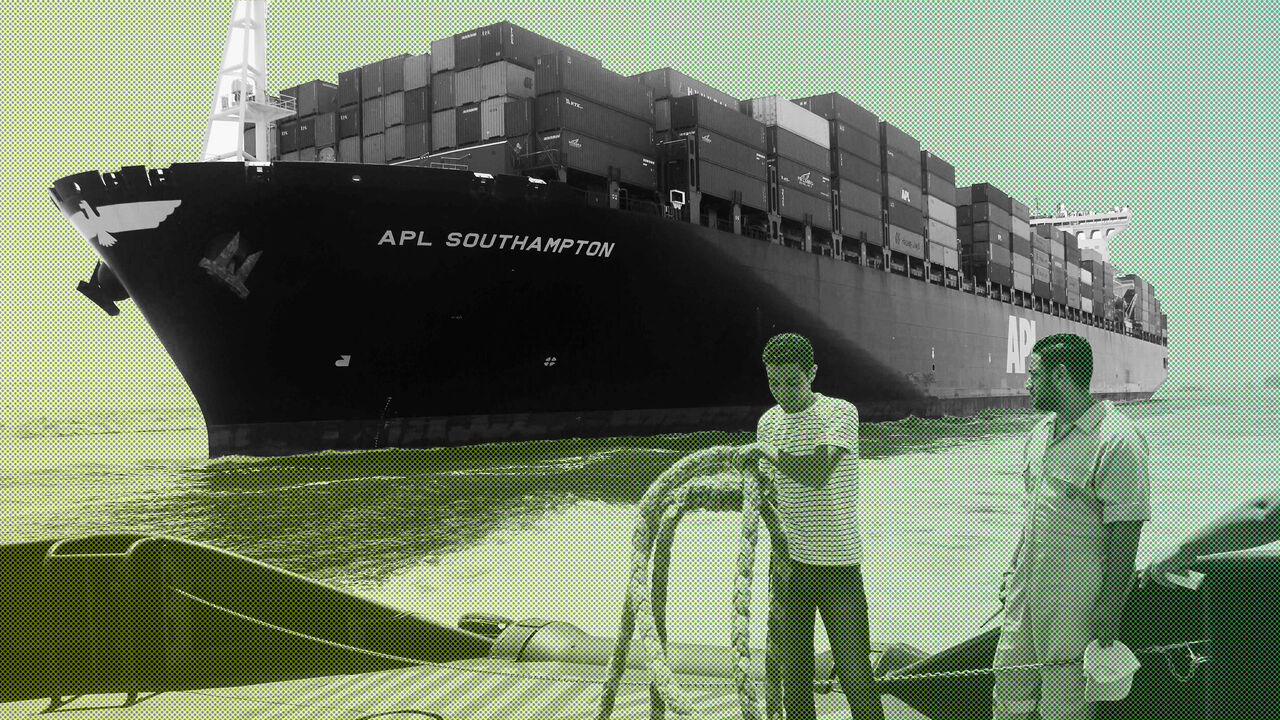 Employees work on a boat in front of a container ship, as they are both crossing the new waterway of the Suez canal on July 25, 2015, in the Egyptian port city of Ismailia, east of Cairo. Egypt began the first trial run of its "new Suez canal," officials and state media said, ahead of the formal inauguration of the new shipping route on August 6. Dubbed the Suez Canal Axis, the new 72-kilometre (45 mile) project is aimed at speeding up traffic along the existing waterway by reducing the waiting period of ve