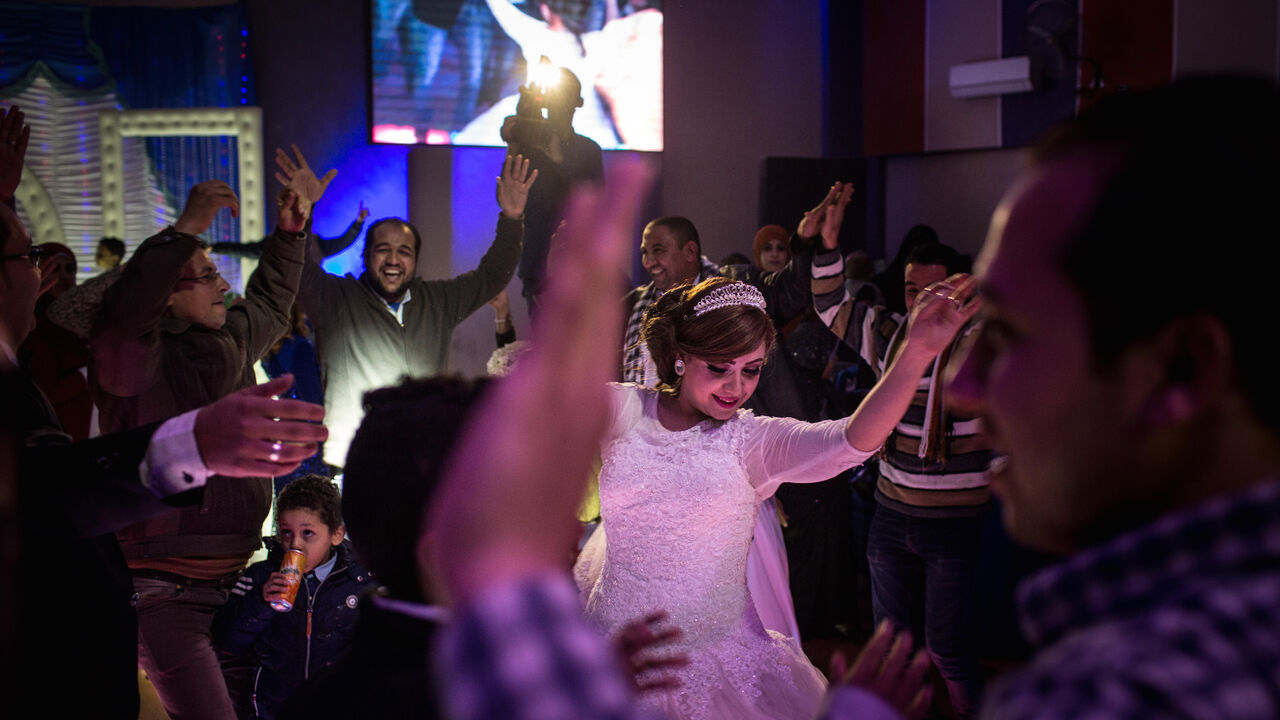 93870862 CAIRO, EGYPT - DECEMBER 18: A bride dances during a traditional Egyptian wedding party on December 18, 2016 in Cairo, Egypt. Since the 2011 Arab Spring, Egyptians have been facing a crisis, the uprising brought numerous political changes, but also economic turmoil, increased terror attacks and the unravelling of the once strong tourism sector. In recent weeks Egypt has again been hit by multiple bomb blasts, the most recent killed 26 Christians inside the St Peter and St Paul Church during Sunday mass. As C