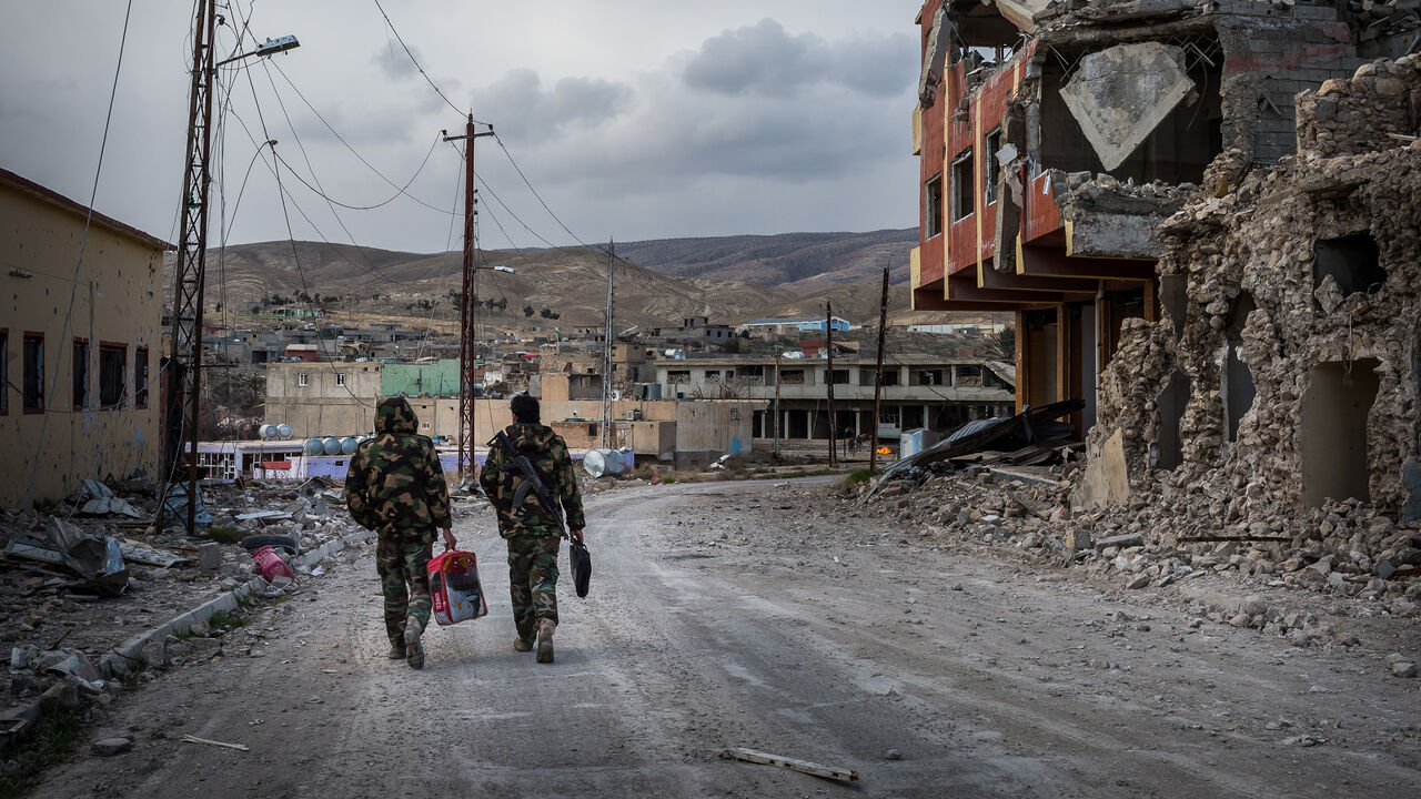 ar_iraq_079.jpg 25 Jan 2016 - Sinjar, Iraq. Kurds Peshmerga walks through the ruins of the city which had a mixed population of yazidi and muslims kurds. The city has been invaded by ISIS/Daesh on the 3rd of August 2014. Sinjar has been officially liberated in November 2015 cutting the road used by the jhiadi group as a supply route between Raqqah and Mosul. The city is today a ghost town inhabited almost only by military groups such as Kurds Peshmerga, PKK, Iraqi Police and YBS (Yazidi Sinjar Resistance Units). At present