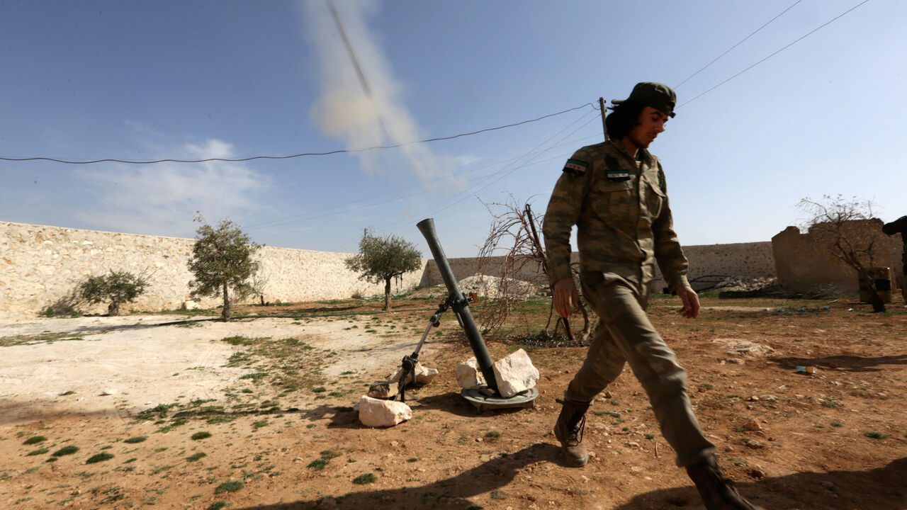MIDEAST-CRISIS/SYRIA A rebel fighter fires a mortar shell towards Syrian army soldiers, west of Manbij city, in Aleppo Governorate, Syria March 9, 2017. REUTERS/Khalil Ashawi - RC1BFF190D80