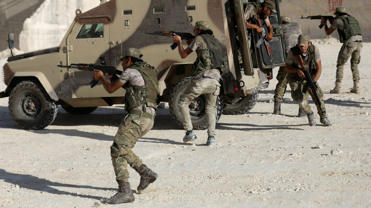 MIDEAST-CRISIS/SYRIA Fighters from Free Syrian Army (National Brigade) demonstrate their skills during a military display as part of a graduation ceremony in the Syrian city of al-Bab, Syria September 27, 2017. REUTERS/Khalil Ashawi - RC13EEB7DF60