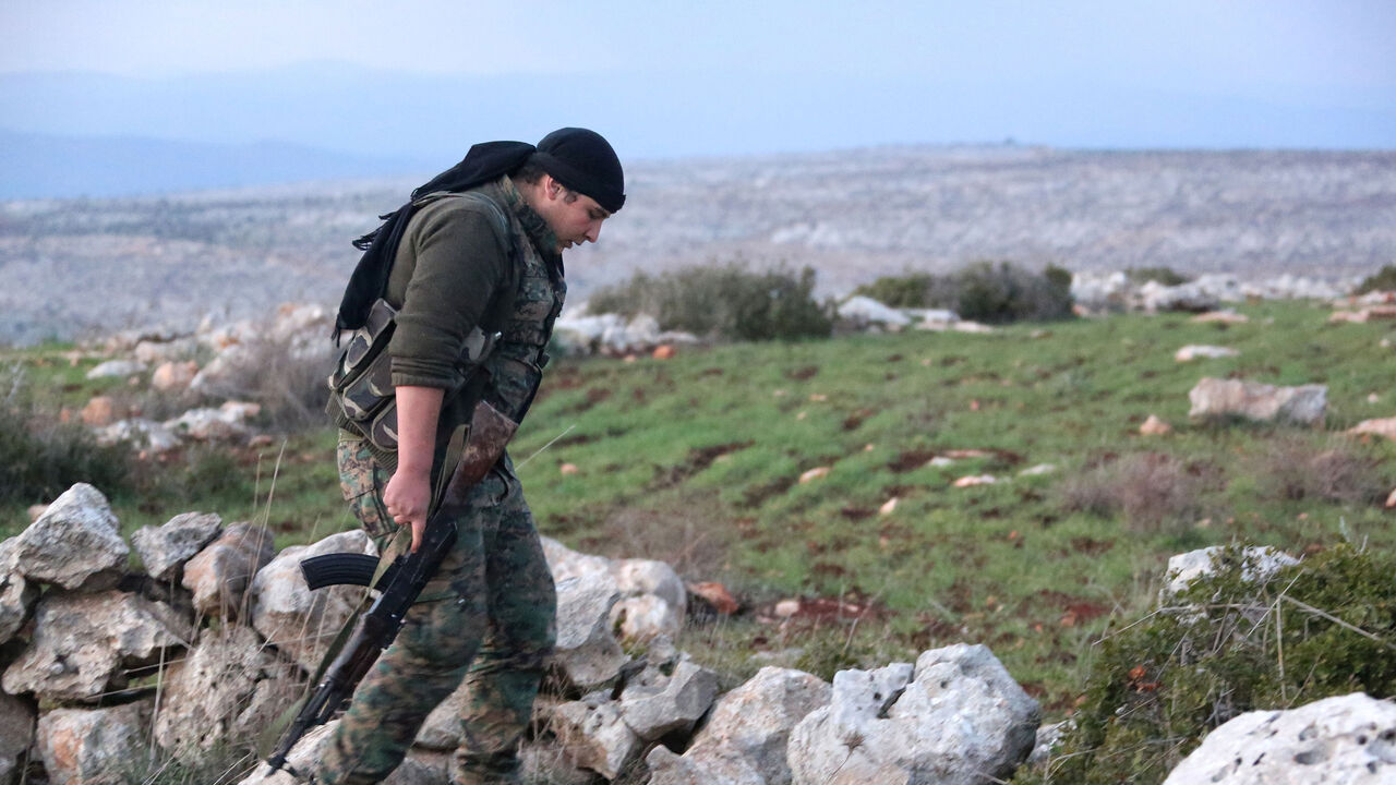 AFP_Y37HD TOPSHOT - A Syrian Kurdish fighter walks in the town of Rajo in the Afrin District on January 27, 2018.
Turkish troops and tanks entered northern Syria on January 21 in an offensive aimed at ousting the Kurdish Peoples' Protection Units (YPG), which Ankara considers a terror group, from the Afrin region bordering Turkey. / AFP PHOTO / STRINGER (Photo credit should read STRINGER/AFP/Getty Images)